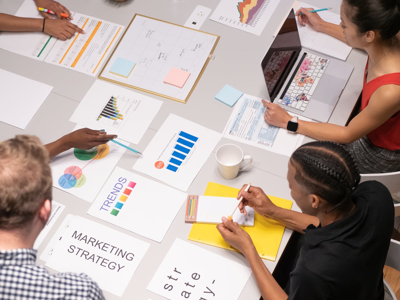 The Art of Drawing Readers In: Your attractive post title goes here Overhead shot of diverse team analyzing marketing strategies with charts and graphs.